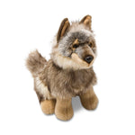 A plush toy representing a wolf with realistic colorings, pointy ears, button eyes, and a bushy tail.